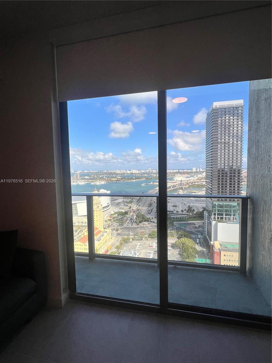 A high-rise apartment balcony overlooks a city skyline, a bridge, and a bay — 121 NE 5th st # 3400, Miami FL 33132, MIAMI, FL