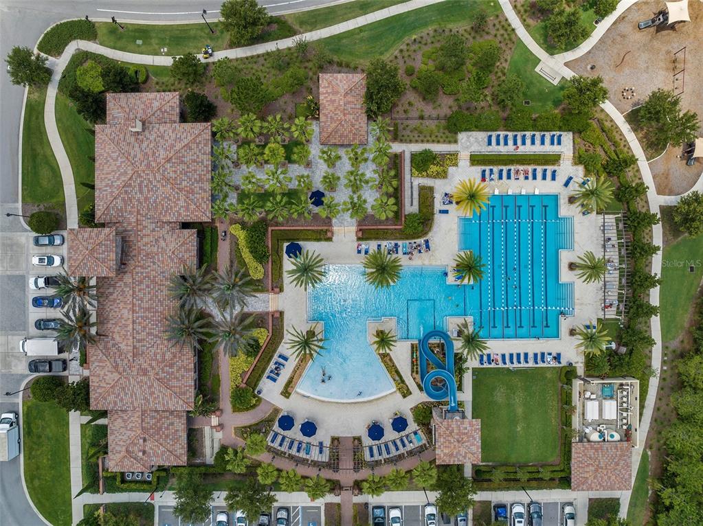 Aerial view of a community clubhouse featuring a large swimming pool with a water slide — 4020 EMPOLI COURT, WESLEY CHAPEL, FL