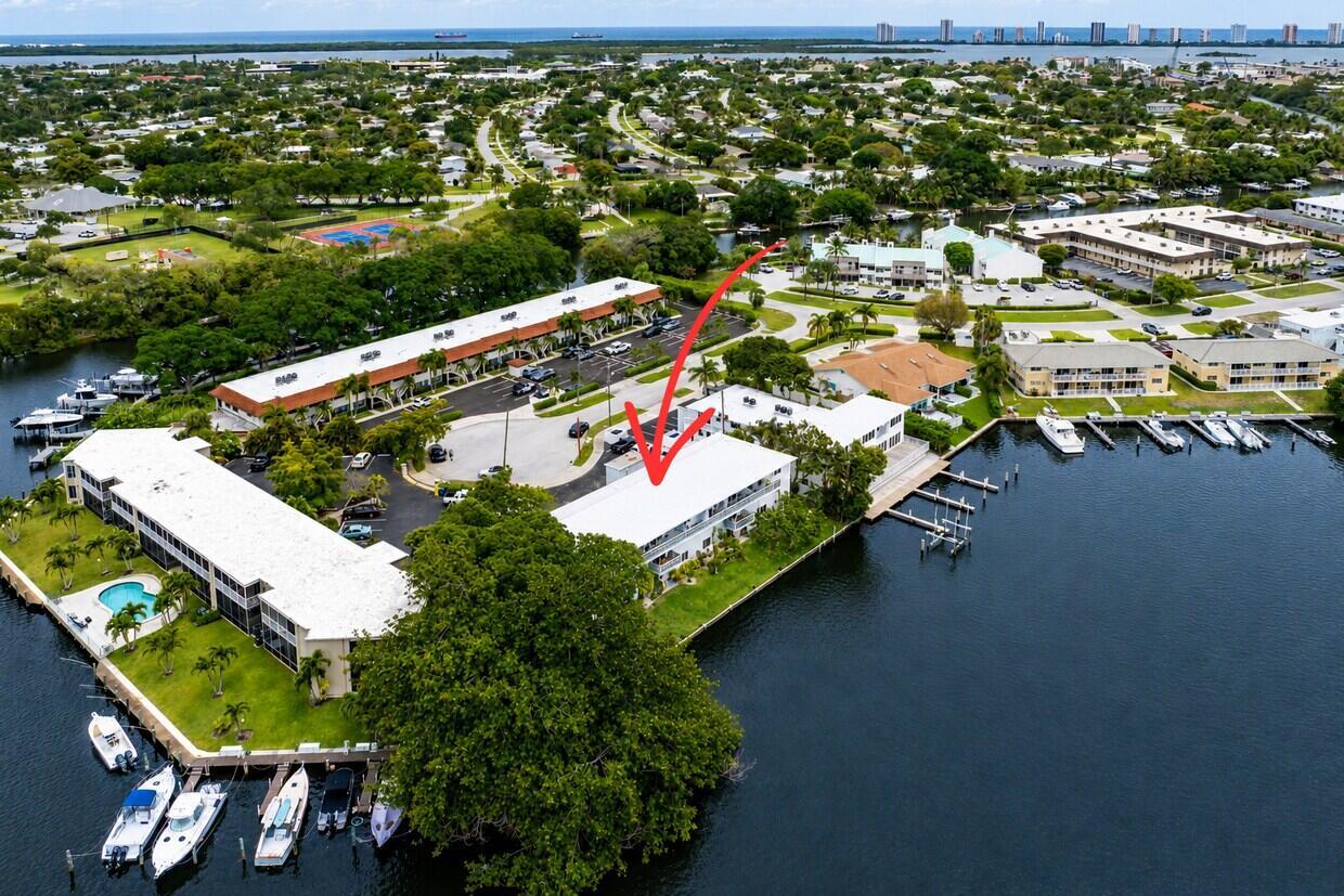 Aerial view of a waterfront apartment complex with boat slips and a parking lot — 628 Southwind Circle, North Palm Beach FL 33408, NORTH PALM BEACH, FL