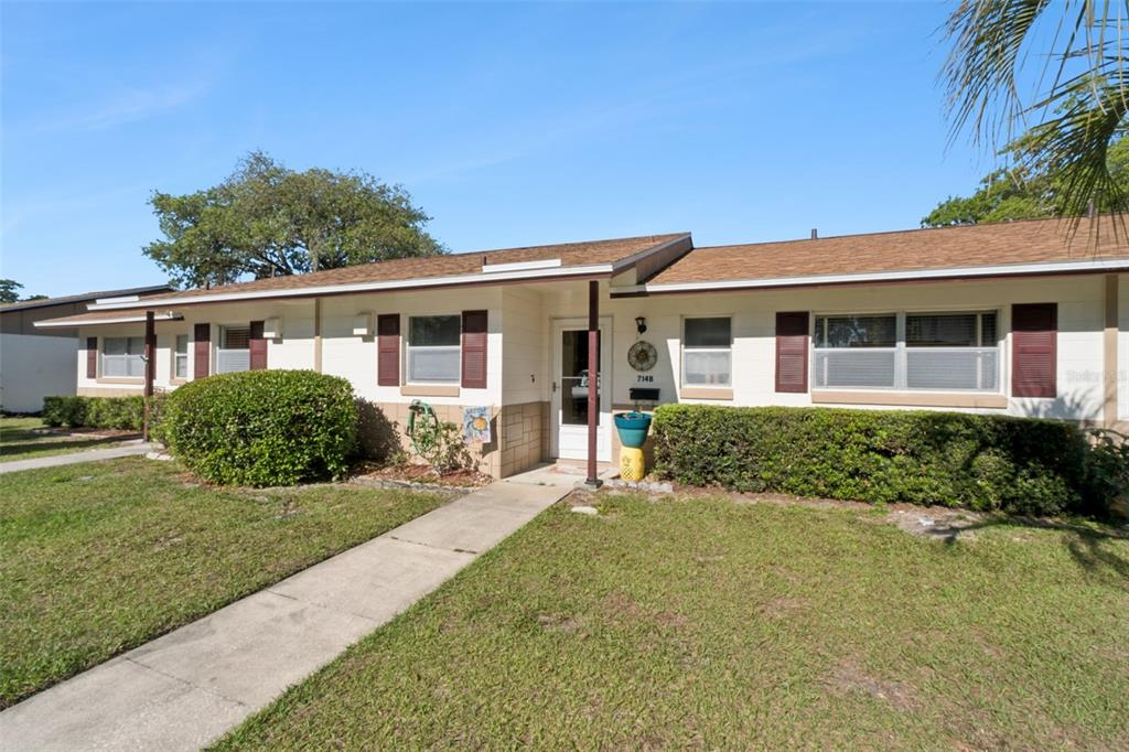 A single-story house with a white exterior, brown roof, and dark shutters — 714 E MINNESOTA AVENUE UNIT B, DELAND, FL
