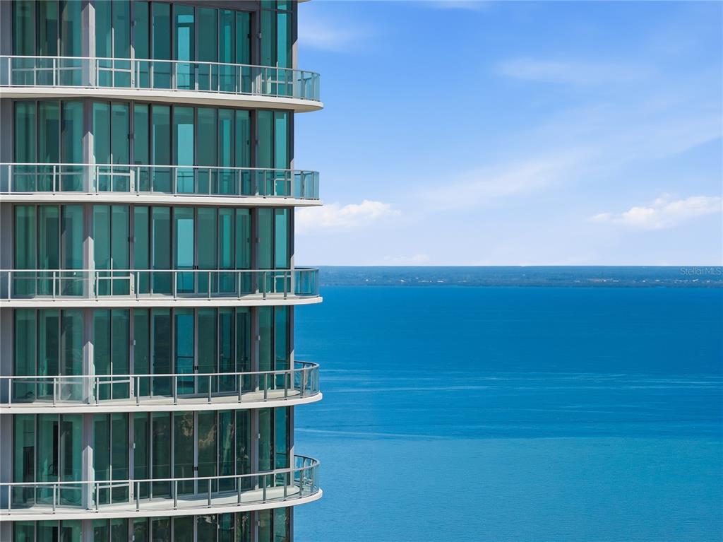 A high-rise building exterior with glass balconies overlooking a large body of water — 400 CENTRAL AVENUE UNIT 3506, ST PETERSBURG, FL