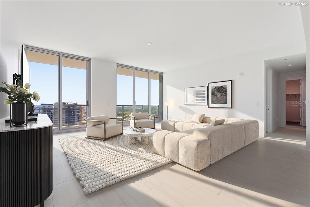 A bright living room with a modular sofa, two armchairs, and floor-to-ceiling windows — 400 CENTRAL AVENUE UNIT 3506, ST PETERSBURG, FL