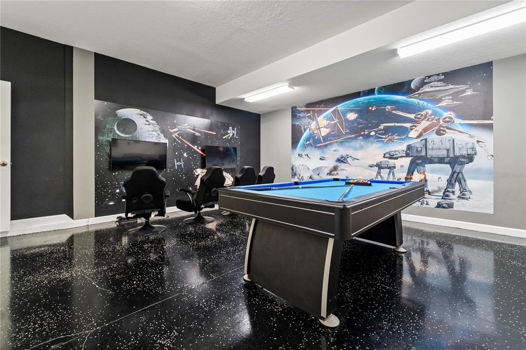 A game room features a pool table, gaming chairs, and Star Wars-themed wall murals — 1571 PALMERO WAY, DAVENPORT, FL
