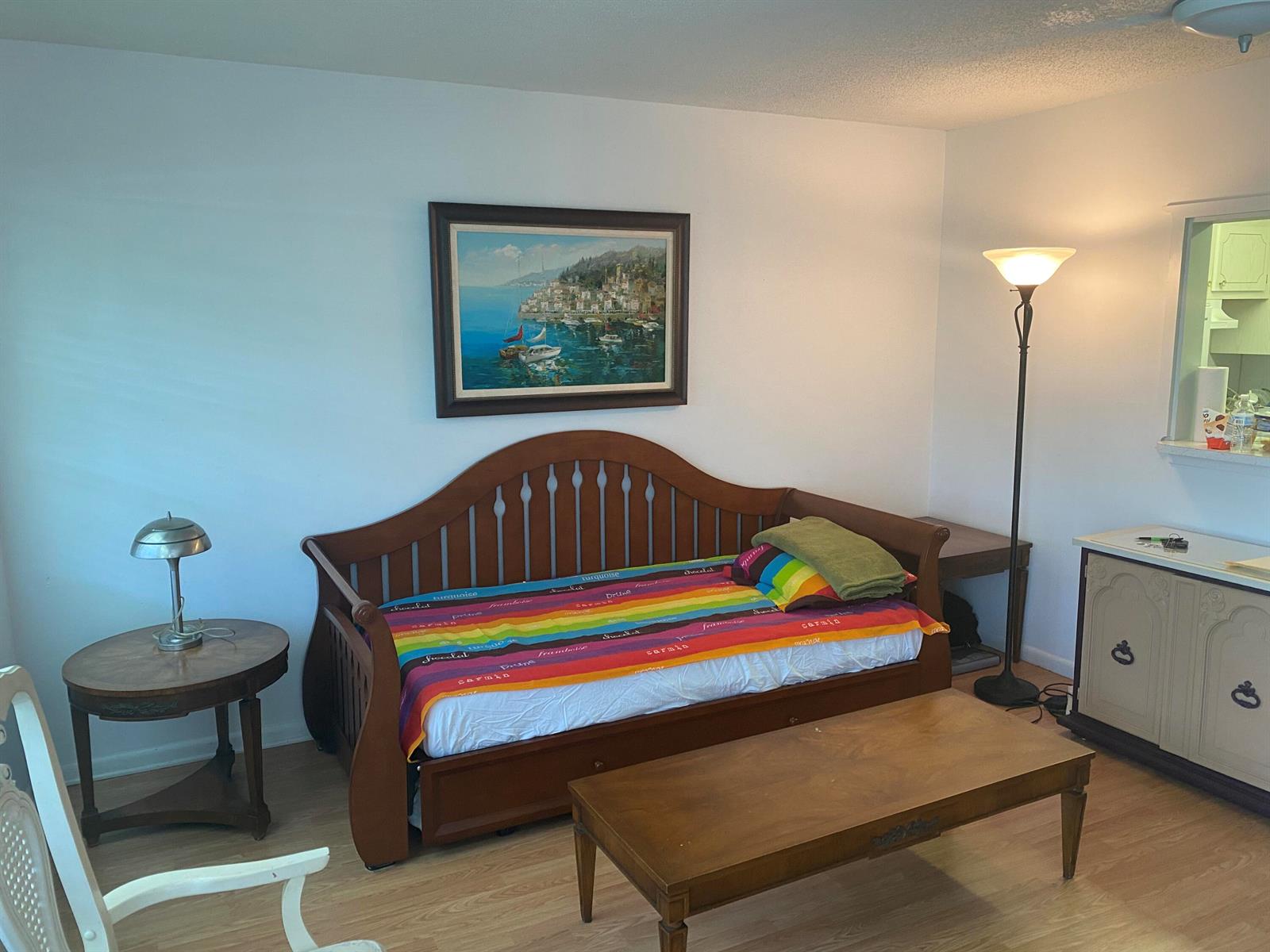 A living room features a wooden daybed with a rainbow blanket and a framed painting — 71 Berkshire # 71, West Palm Beach FL 33417, WEST PALM BEACH, FL