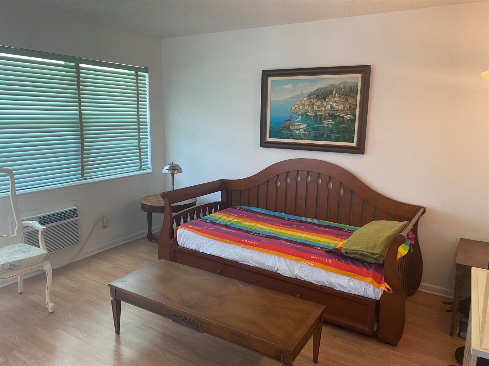 A bedroom features a wooden daybed, a coffee table, a chair, and a framed wall painting — 71 Berkshire # 71, West Palm Beach FL 33417, WEST PALM BEACH, FL