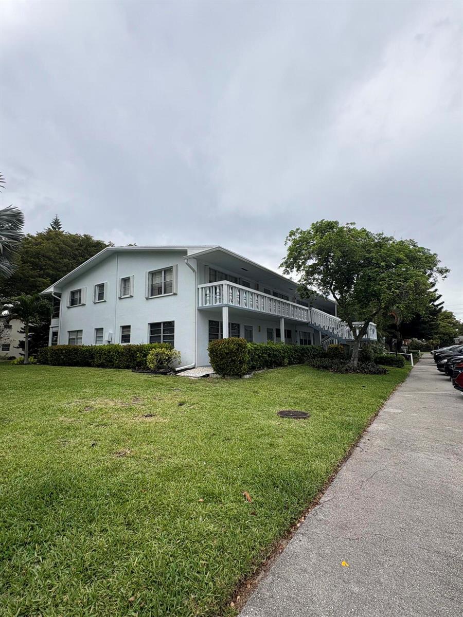 A two-story light blue apartment building features a long balcony and a grassy lawn — 315 Tilford O # 315, Deerfield Beach FL 33442, DEERFIELD BEACH, FL
