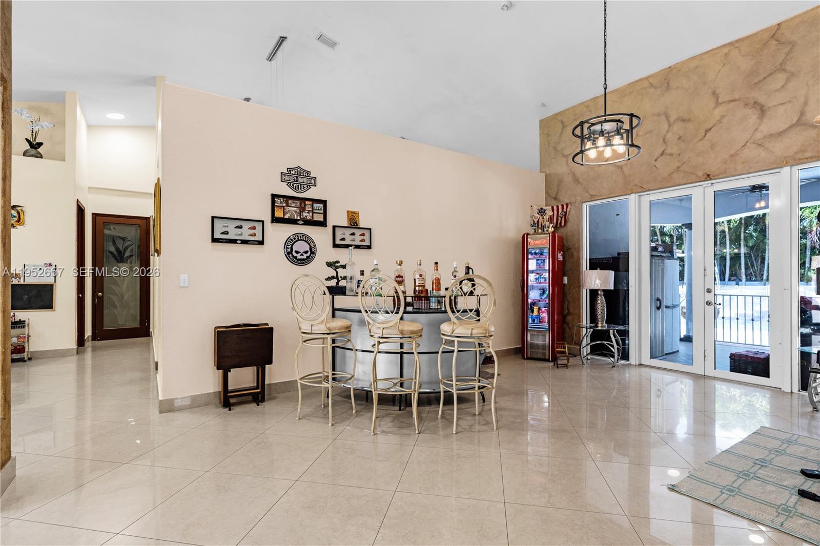 A room features a curved home bar with three stools and a Coca-Cola refrigerator — 12969 SW 220th Ter, Miami FL 33170, MIAMI, FL