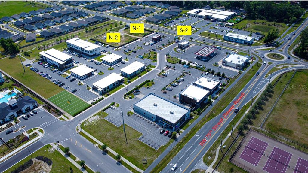 An aerial view shows a commercial development with multiple buildings, parking lots, and surrounding roads — 7379 SW 17TH ROAD UNIT S-2, GAINESVILLE, FL