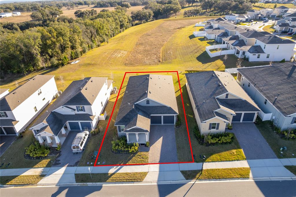An aerial view shows a single-family home outlined in red within a suburban neighborhood — 2060 KEYSTONE PASS BOULEVARD, MINNEOLA, FL