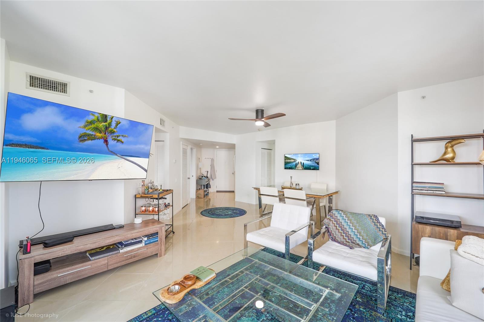A living and dining area features white walls, tile floors, and modern furniture — 701 Brickell Key Blvd # 404, Miami FL 33131, MIAMI, FL