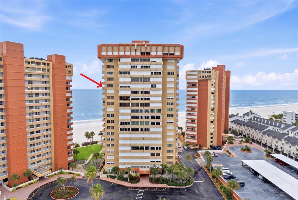 An aerial view of three high-rise apartment buildings and a swimming pool at sunset — 17920 GULF BOULEVARD UNIT 1502, ST PETERSBURG, FL