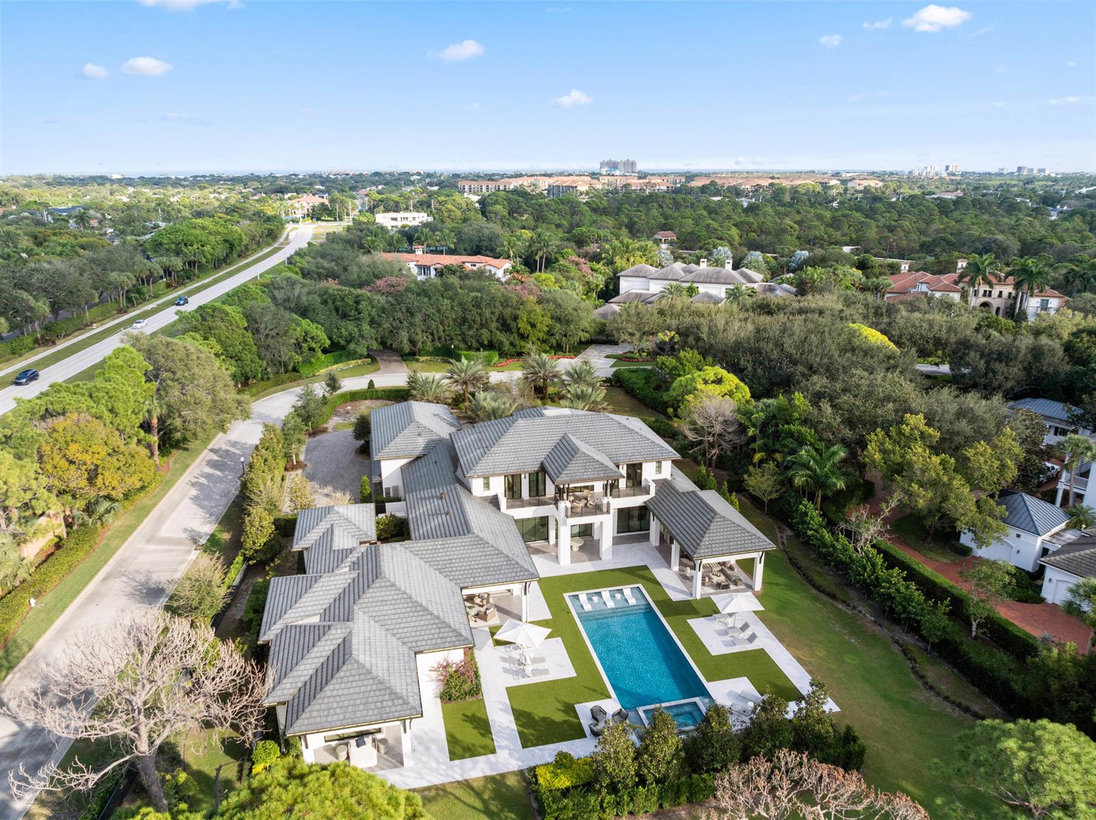 An aerial view of a large house with a swimming pool and landscaped backyard — 210 Bears Club Drive, Jupiter FL 33477, JUPITER, FL