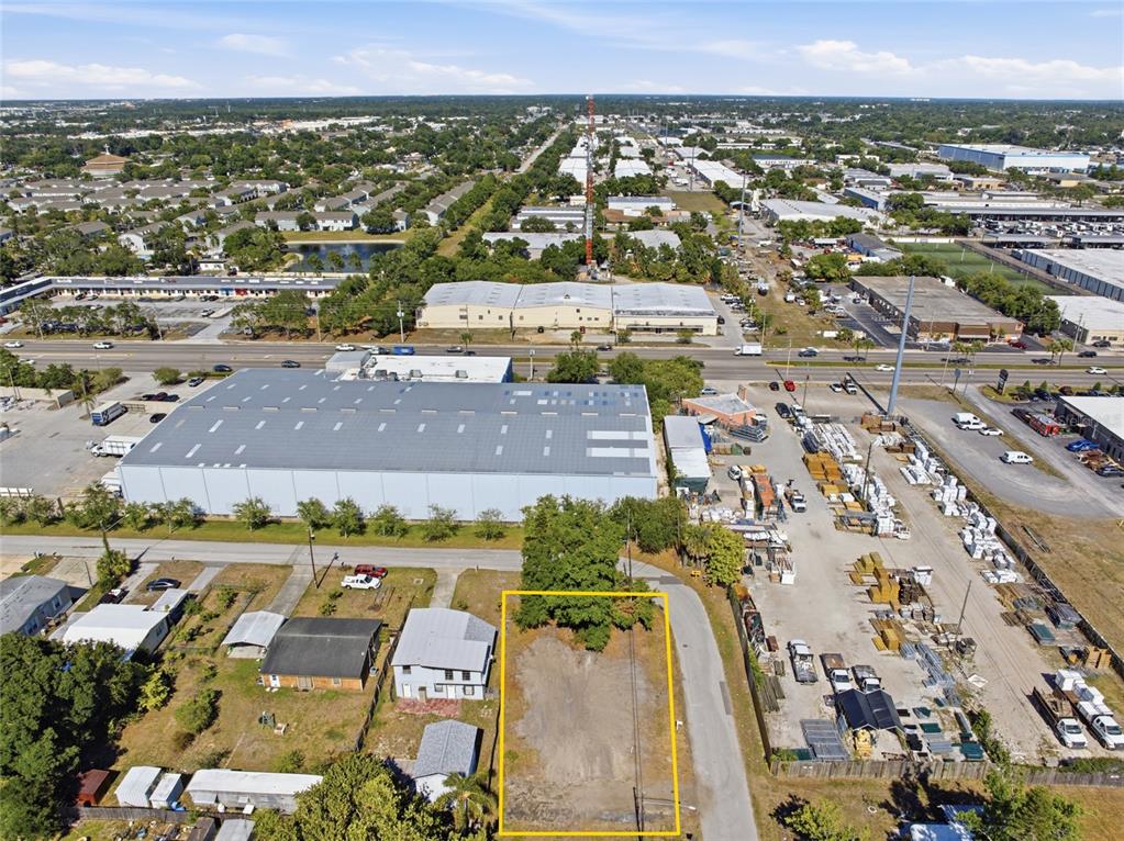 An aerial view shows a vacant rectangular lot outlined in yellow next to residential buildings — 6500 49TH WAY N, PINELLAS PARK, FL