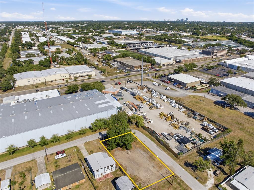An aerial view shows a vacant rectangular lot outlined in yellow next to a house — 6500 49TH WAY N, PINELLAS PARK, FL