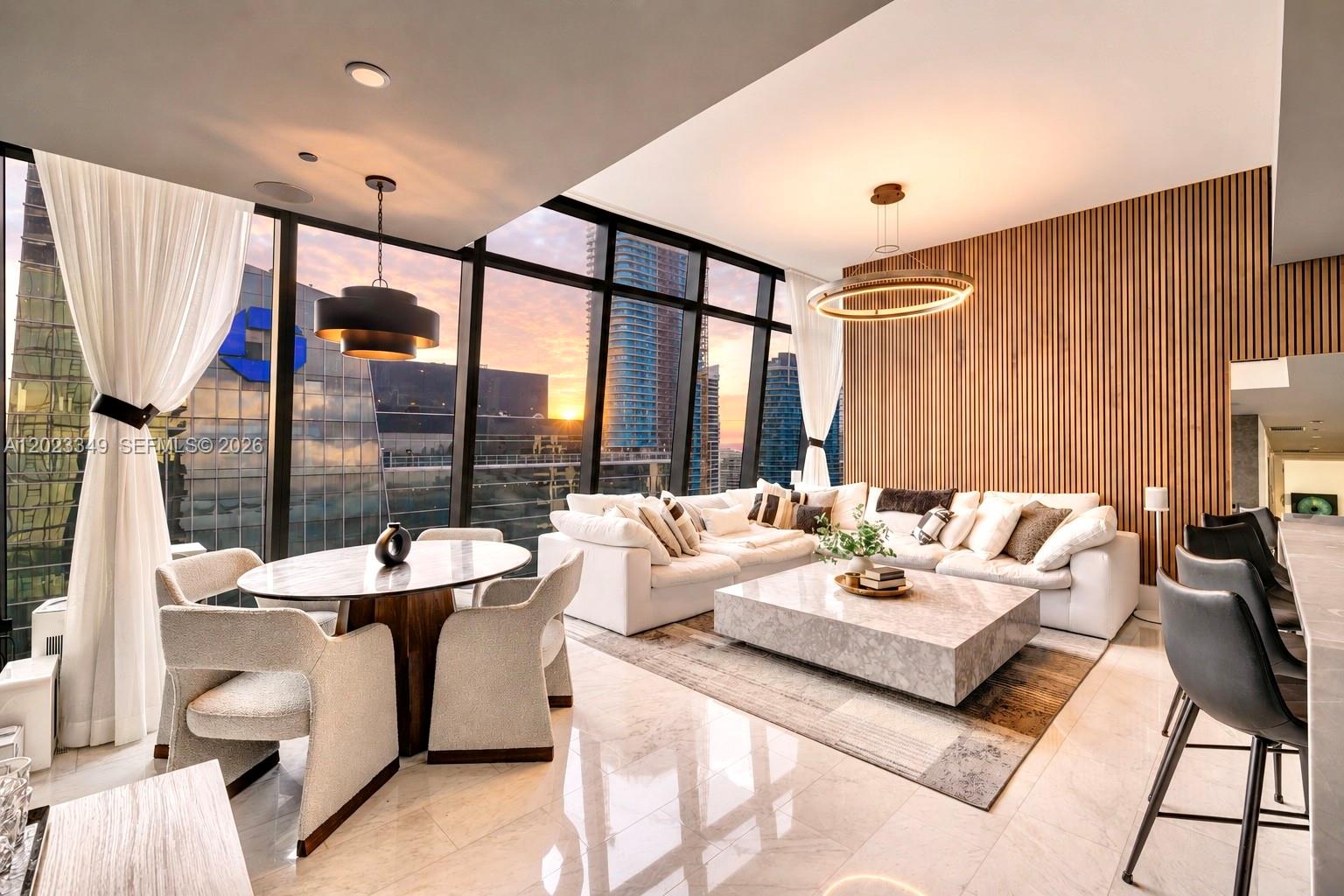 A modern living and dining area features floor-to-ceiling windows, wood-slat walls, and marble flooring — 1451 Brickell Ave # 4304, Miami FL 33131, MIAMI, FL