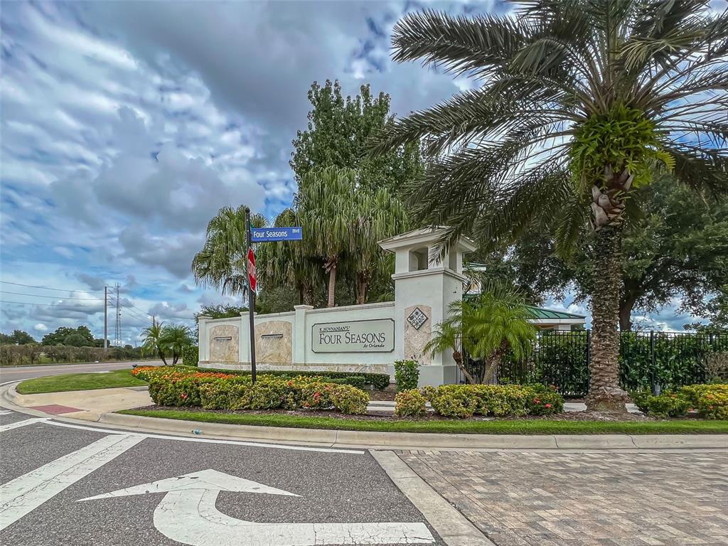 The entrance sign for K. Hovnanian's Four Seasons at Orlando features landscaping and a palm tree — 2074 FLORA PASS PLACE, KISSIMMEE, FL