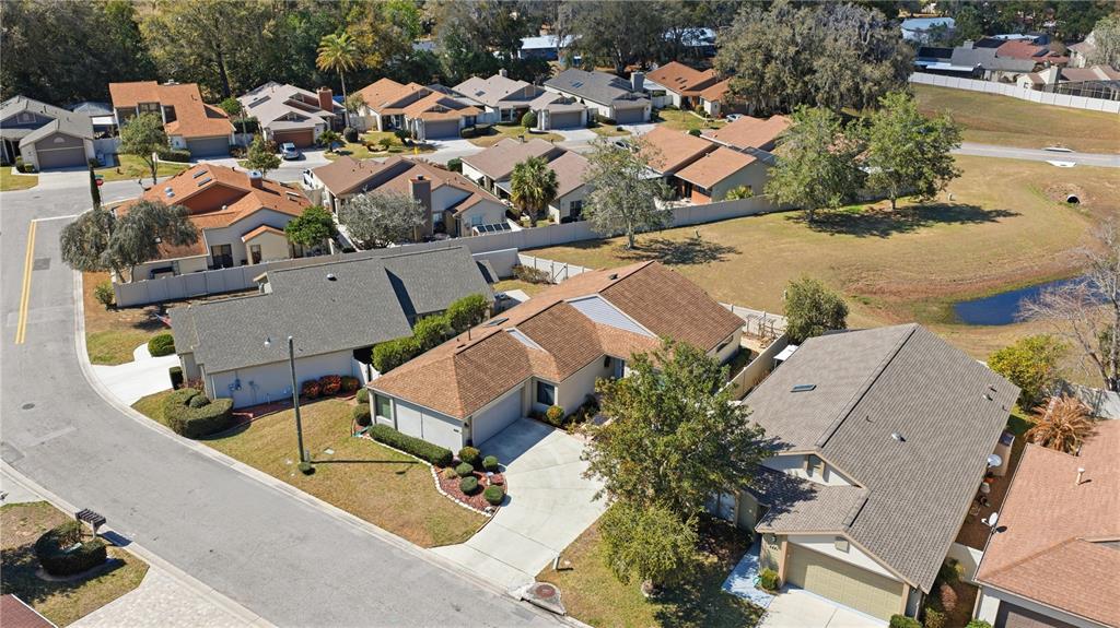 An aerial view shows several suburban houses with brown roofs and driveways in a neighborhood — 4427 NE 5TH STREET, OCALA, FL