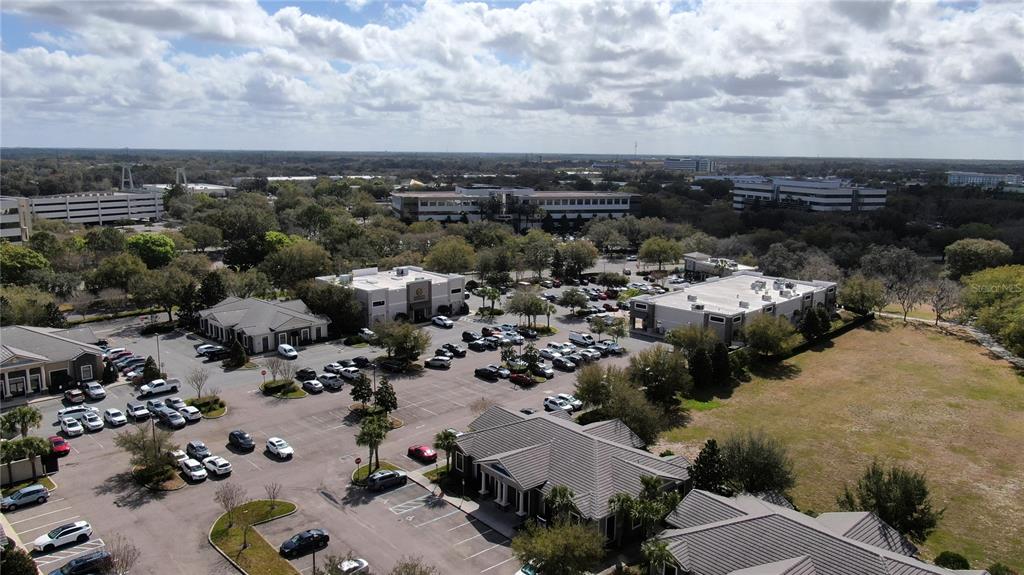 An aerial view shows a commercial office park with multiple buildings and parking lots — 938 INTERNATIONAL PARKWAY UNIT 1510, LAKE MARY, FL