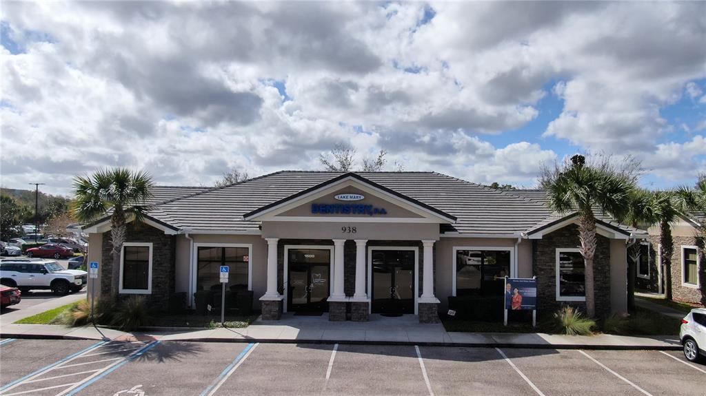 A single-story commercial building with a stone facade and a gray tiled roof — 938 INTERNATIONAL PARKWAY UNIT 1510, LAKE MARY, FL
