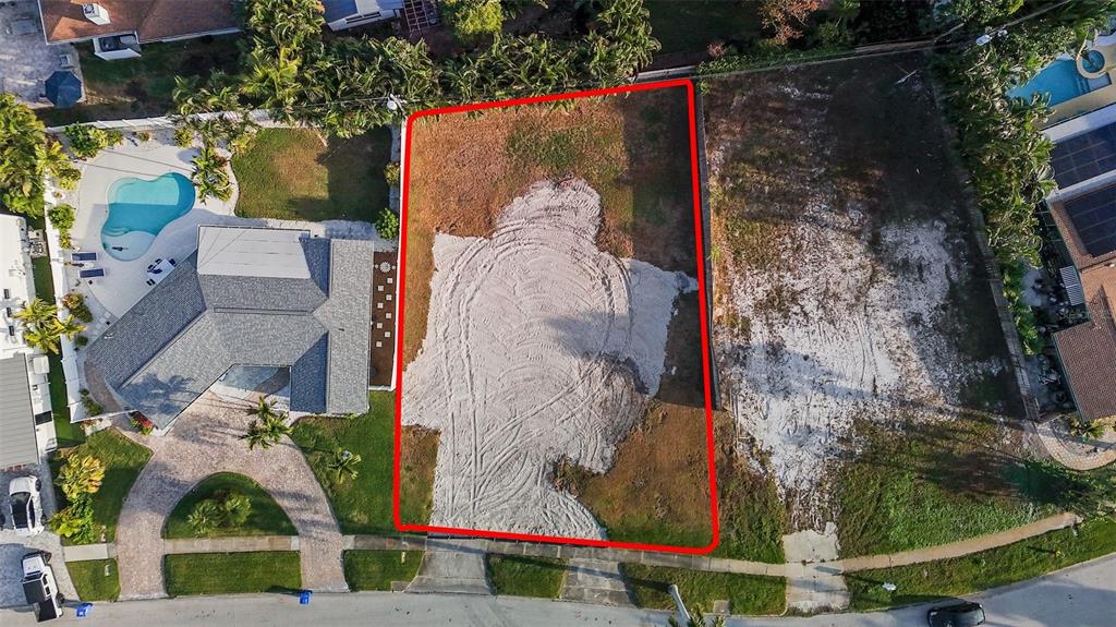An aerial view shows a vacant, rectangular residential lot outlined in red next to a house — 1235 CORDOVA BOULEVARD NE, ST PETERSBURG, FL