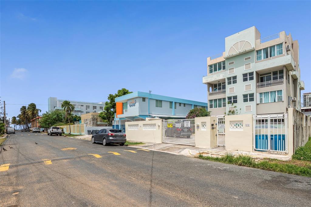 A street view shows a multi-story apartment building next to a light blue commercial structure — Cond. Montemar 101, OCEAN DRIVE UNIT 101, LUQUILLO, PR