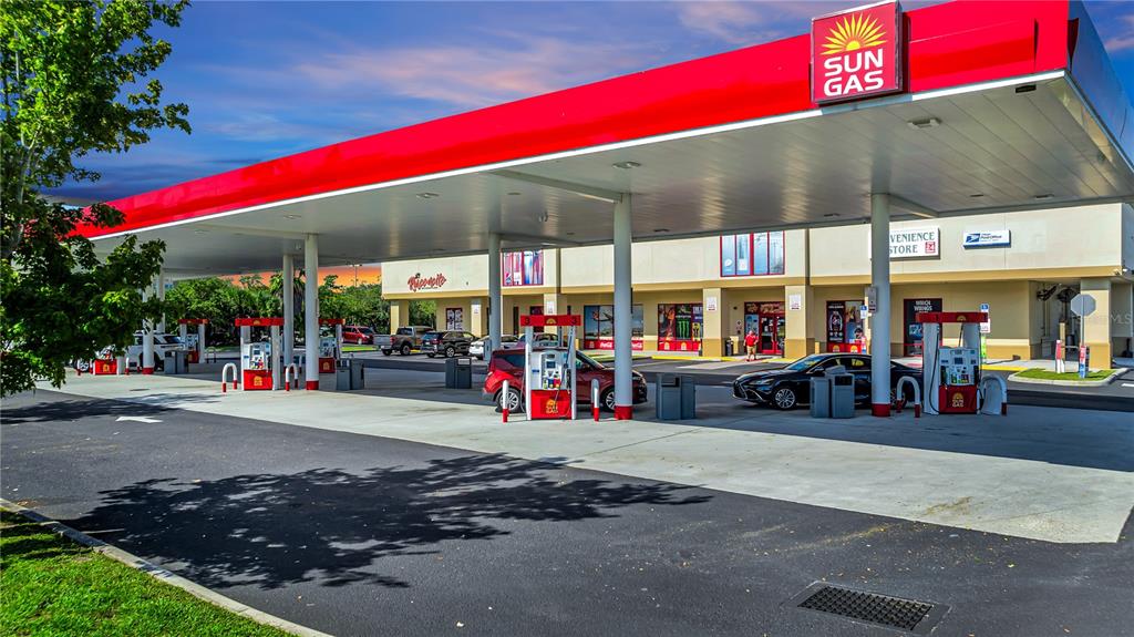 A Sun Gas gas station with multiple fuel pumps under a large red canopy — 5600 BUTLER NATIONAL DRIVE, ORLANDO, FL