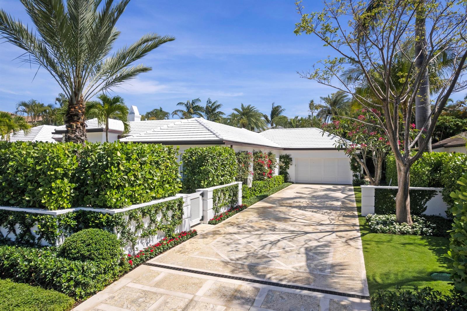 A white house with a tiled roof and a stone driveway behind a gated entrance — 224 Southland Road, Palm Beach FL 33480, PALM BEACH, FL
