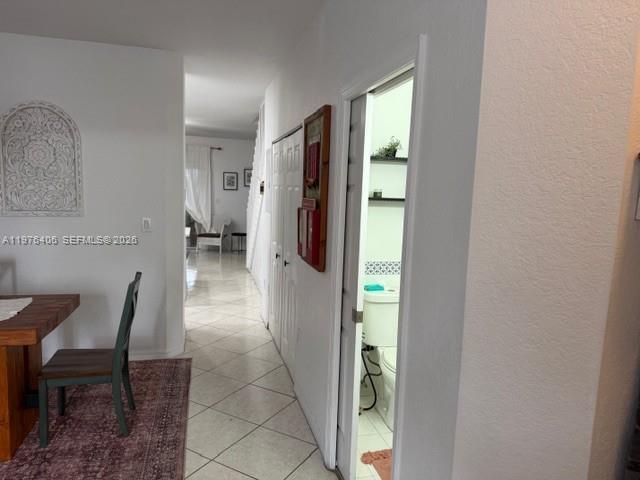 A hallway with tile floors leads past a bathroom and a dining area — 5737 NW 114th Path # 113, Doral FL 33178, DORAL, FL