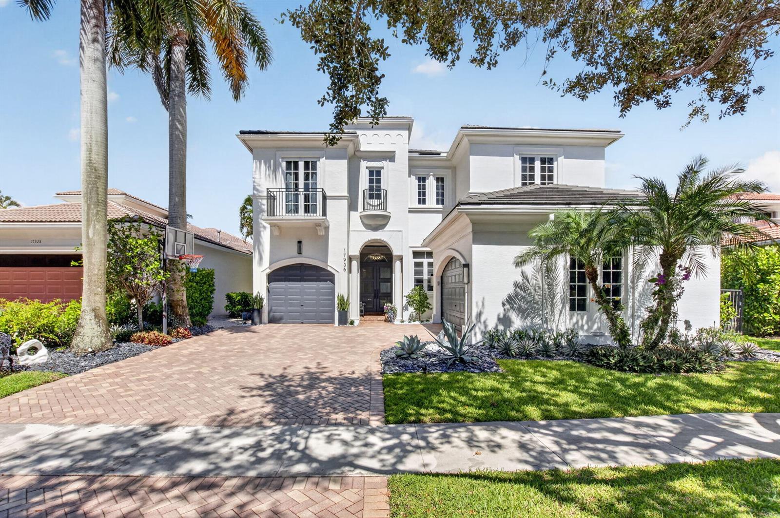 A two-story white stucco house features a brick driveway, two garages, and palm trees — 17936 Villa Club Way, Boca Raton FL 33496, BOCA RATON, FL