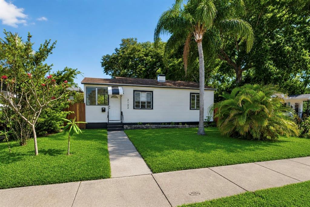A white, single-story house with a palm tree and a front lawn — 2122 6TH AVENUE N, ST PETERSBURG, FL