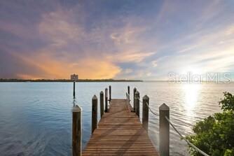 A wooden dock extends into a calm body of water under a sunset sky — 344 50TH STREET W, PALMETTO, FL