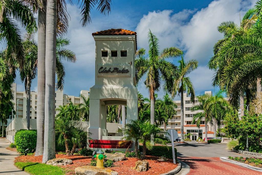 A tall stucco monument sign for Club Bahia stands surrounded by palm trees and landscaping — 6085 BAHIA DEL MAR CIRCLE UNIT 467, ST PETERSBURG, FL