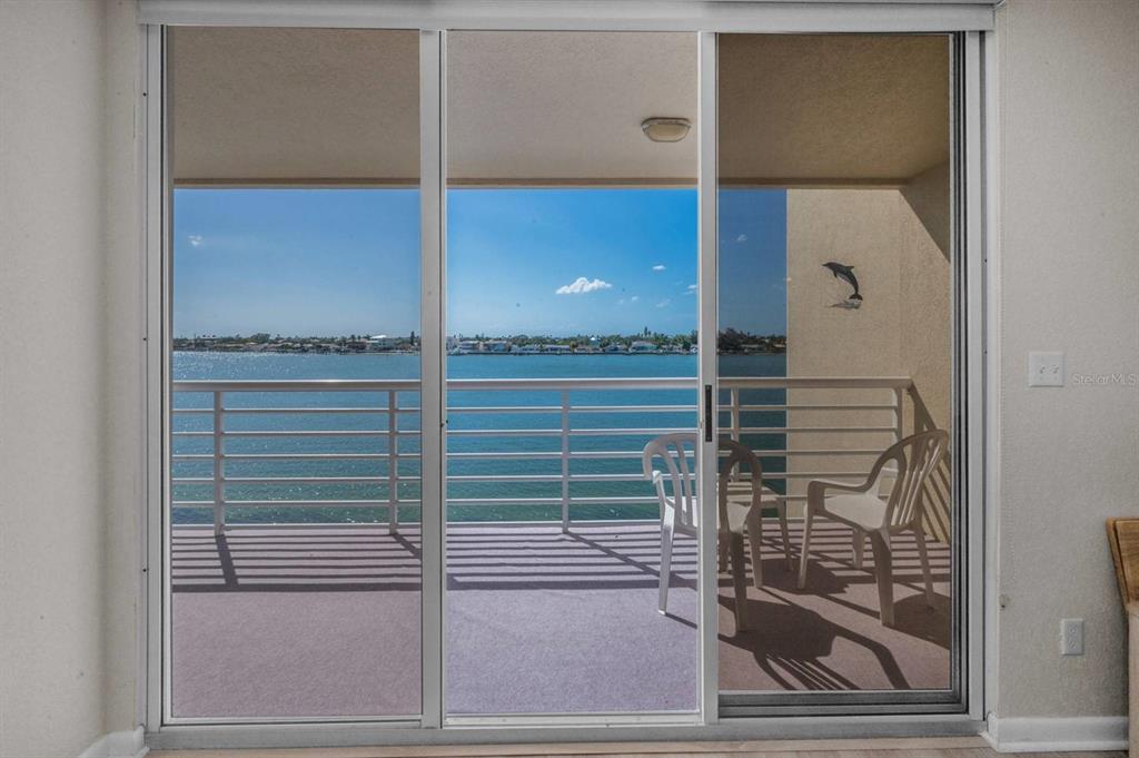 A sliding glass door opens to a balcony overlooking a body of water — 6085 BAHIA DEL MAR CIRCLE UNIT 467, ST PETERSBURG, FL