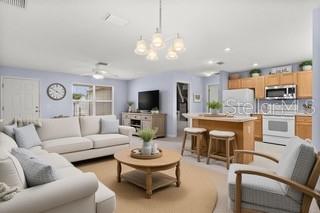 A screened-in porch features wicker furniture, a coffee table, and views of a grassy yard — 3324 CANDLEBROOK STREET, THE VILLAGES, FL