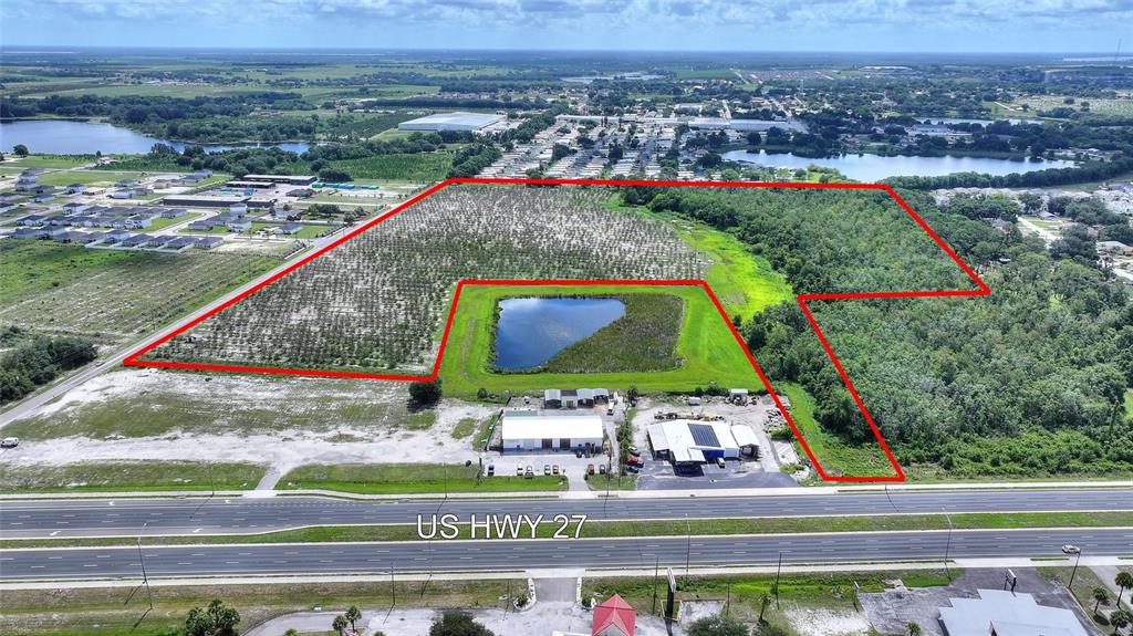 An aerial view shows a large, partially wooded plot of land outlined in red — U S HIGHWAY 27, DUNDEE, FL