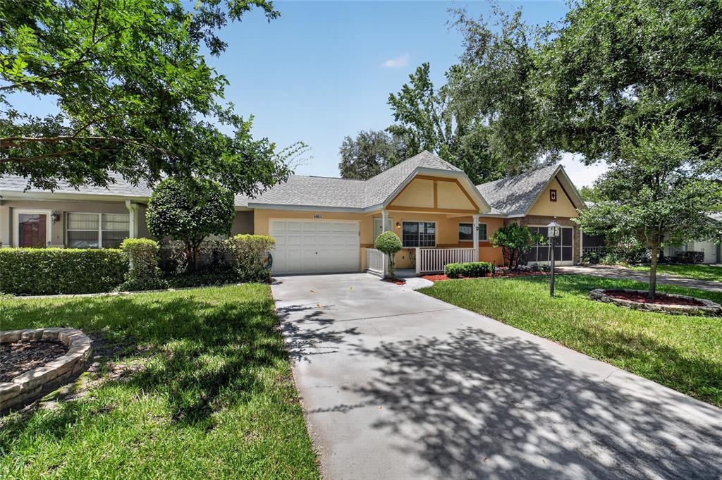 A single-story house with a garage, a covered front porch, and a concrete driveway — 9490 SW 85TH AVENUE UNIT C, OCALA, FL