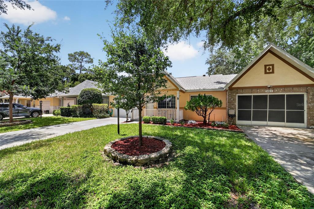 A single-story house with a white garage, a covered porch, and a small front yard — 9490 SW 85TH AVENUE UNIT C, OCALA, FL