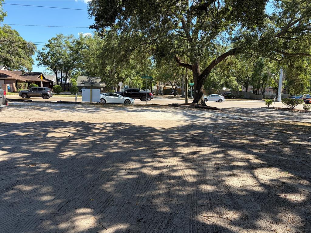 A dirt lot with tire tracks sits in front of a road with passing cars — 312 E DR MARTIN LUTHER KING JR BOULEVARD, TAMPA, FL