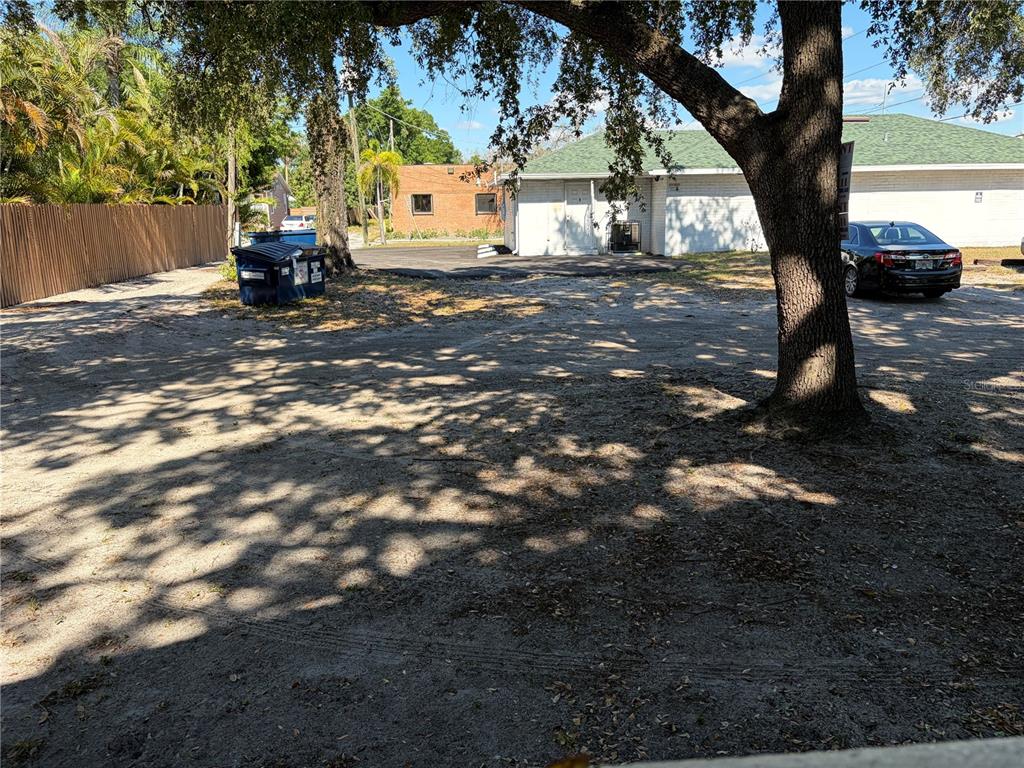 A gravel parking area sits in front of a white building with a green roof — 312 E DR MARTIN LUTHER KING JR BOULEVARD, TAMPA, FL