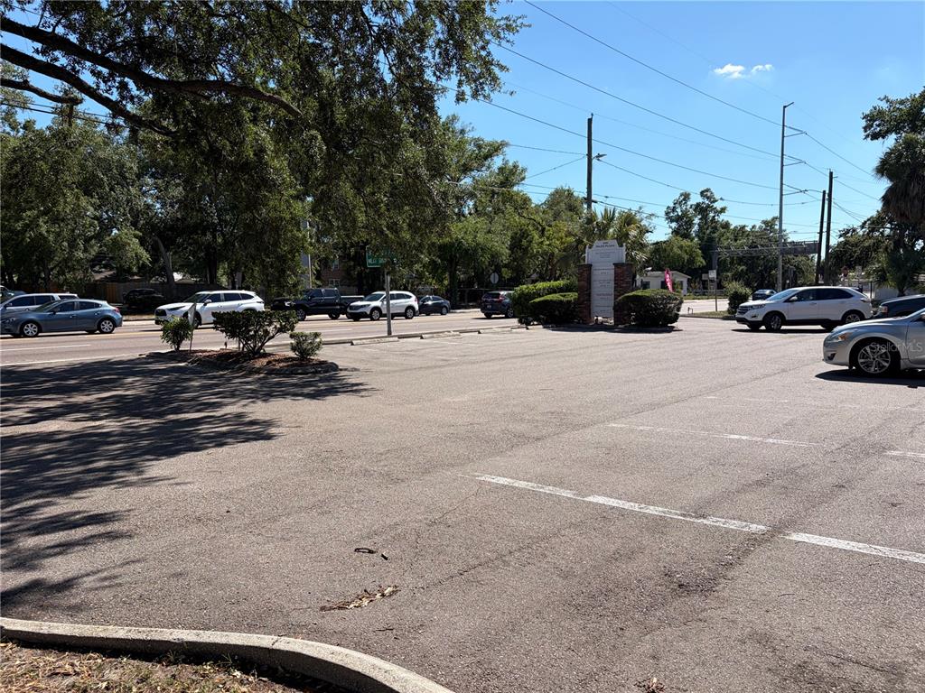 A paved parking lot sits in front of a commercial building with a tall sign — 312 E DR MARTIN LUTHER KING JR BOULEVARD, TAMPA, FL