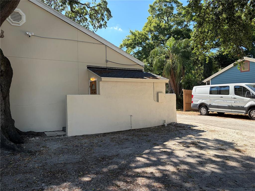 A side view of a beige building with a small attached shed and a white van — 312 E DR MARTIN LUTHER KING JR BOULEVARD, TAMPA, FL