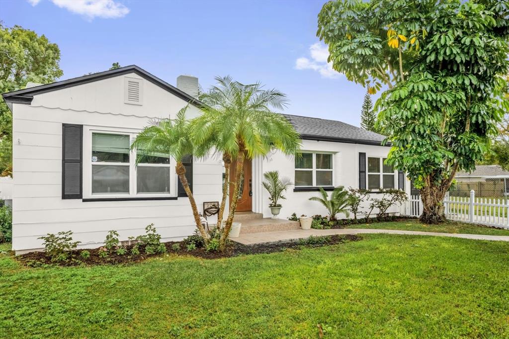 A white single-story house with black shutters, a palm tree, and a front lawn — 918 W SMITH STREET, ORLANDO, FL