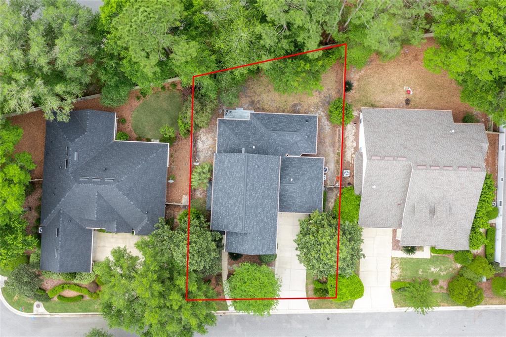 An aerial view shows a house with a dark roof and a concrete driveway — 9255 SW 29 AVENUE, GAINESVILLE, FL
