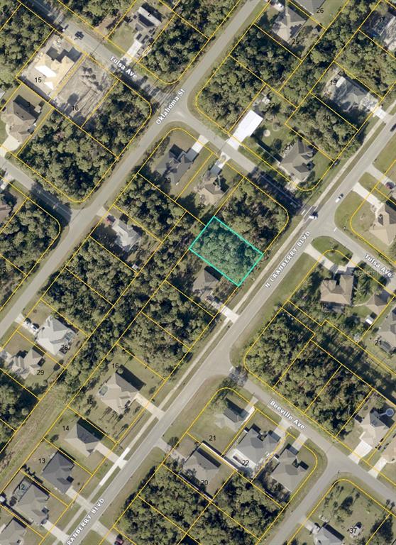 An aerial map shows a vacant, wooded residential lot outlined in blue along a road — N CRANBERRY BOULEVARD, NORTH PORT, FL