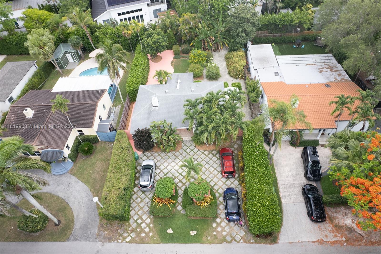 An aerial view shows three residential houses with driveways, lush landscaping, and swimming pools — 4245 Braganza Ave, Miami FL 33133, MIAMI, FL