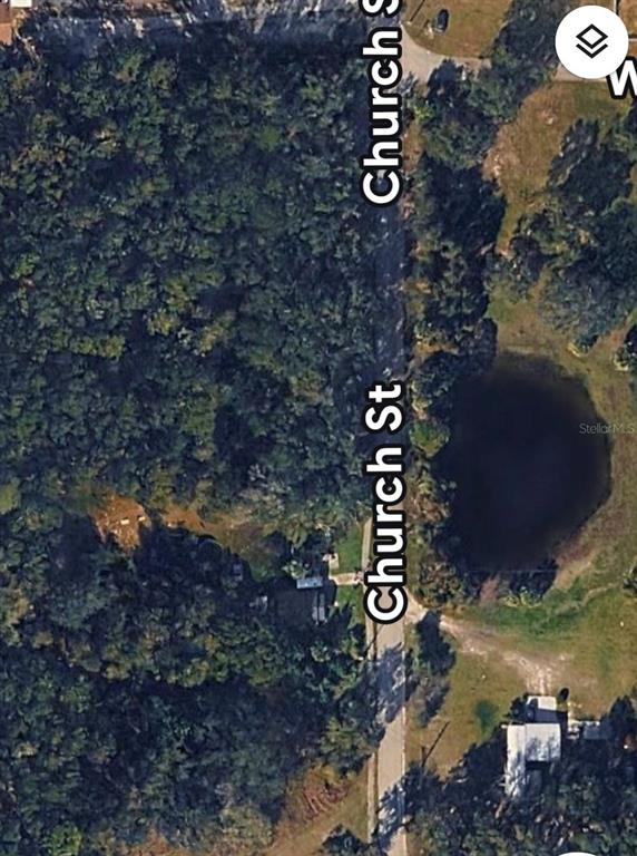 This is an aerial map view showing a wooded lot and a pond along Church Street — 462 CHURCH STREET, LAKE HELEN, FL