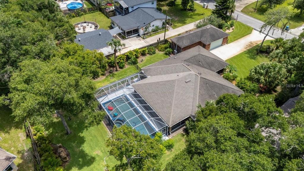 An aerial view shows a house with a screened-in pool and a detached garage — 1165 GEORGE ANDERSON STREET, ORMOND BEACH, FL