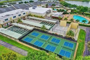An aerial view shows a community complex with pickleball courts, a swimming pool, and buildings — 38 Northampton B # 38, West Palm Beach FL 33417, WEST PALM BEACH, FL