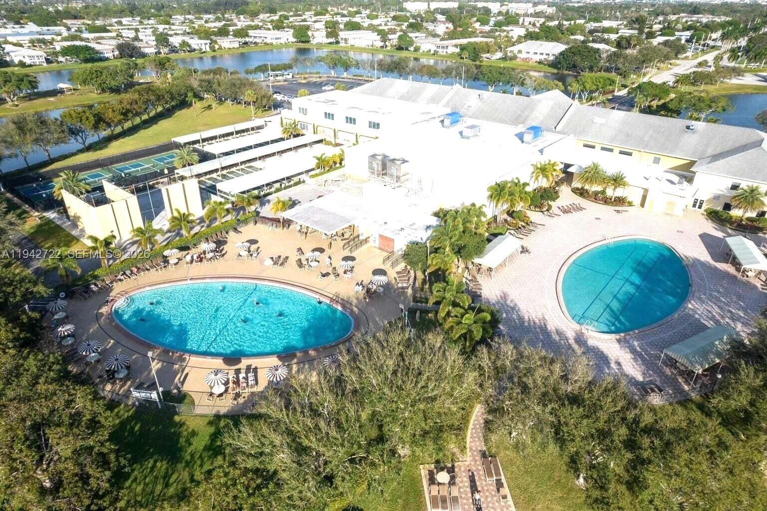 An aerial view shows a large building complex with two swimming pools and tennis courts — 38 Northampton B # 38, West Palm Beach FL 33417, WEST PALM BEACH, FL
