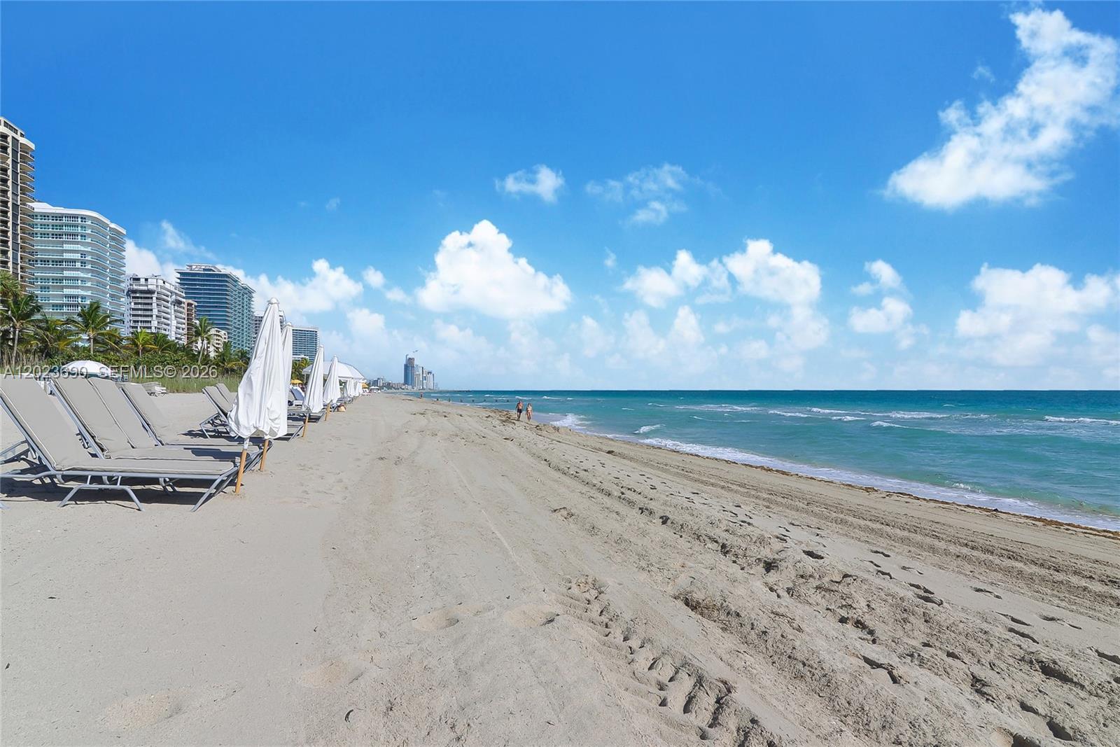 A sandy beach features rows of lounge chairs and umbrellas beside the ocean — 9801 Collins Ave # 11M, Bal Harbour FL 33154, BAL HARBOUR, FL